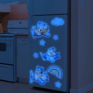 Glow-in-the-dark wall stickers with blue luminous cartoon animals in a dark room scene