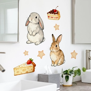 Detail of watercolor rabbit and cake wall stickers on clean bathroom wall tile background