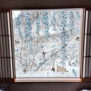 Creative blue floral and bird static window cling set on a glass window with snow background