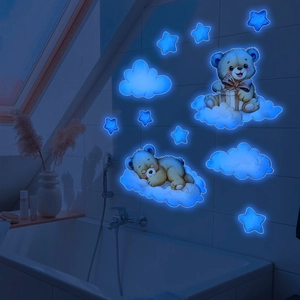 Luminous wall stickers featuring cartoon bears and stars glowing blue in the dark room
