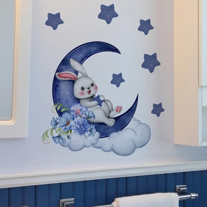 Luminous cartoon rabbit wall sticker with blue moon and stars on white wall surface