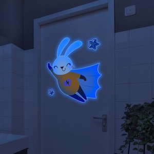Luminous cartoon superhero bunny wall sticker glowing in dark on a white door