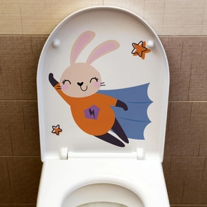 Detail of creative luminous toilet sticker featuring a cartoon superhero rabbit design
