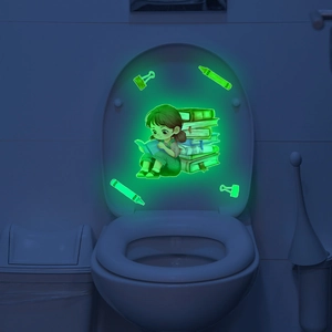 Luminous wall sticker showing a girl reading on a toilet cover in a dark bathroom setting