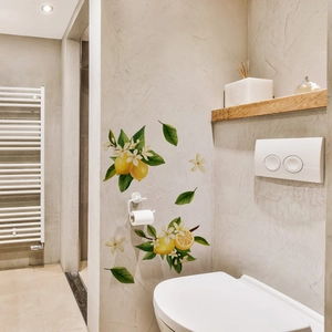 Detailed view of luminous lemon and flower wall stickers in a modern bathroom setting