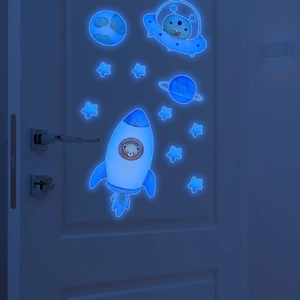 Luminous space wall stickers featuring blue glowing rocket, UFO and stars on white door