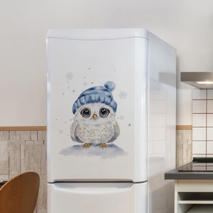 Detailed view of watercolor owl wall sticker with blue hat on a white fridge