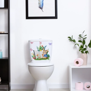Close-up of a cartoon rabbit reading on a toilet sticker with floral and butterfly accents