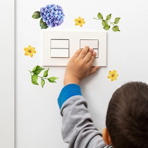 Glow-in-the-dark elf girl floral wall sticker detail applied around a light switch