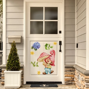 Detailed view of glowing gnome and mushroom wall decals applied on a white home entrance door
