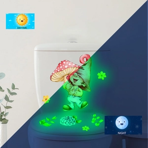Luminous wall sticker showing gnome and mushroom in daytime and night green glow effect