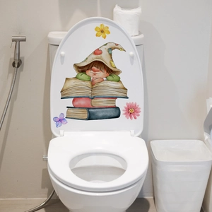 Detailed view of luminous fairy sticker and floral accents applied on a white toilet cover