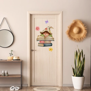 Detailed view of luminous cartoon elf and flowers wall sticker on a wooden door