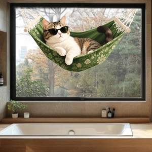 Cat lounging in a green floral canvas hammock with wooden supports in a modern bathroom