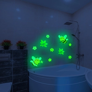 Glow-in-the-dark wall stickers with cartoon bees and flowers in a bathroom setting