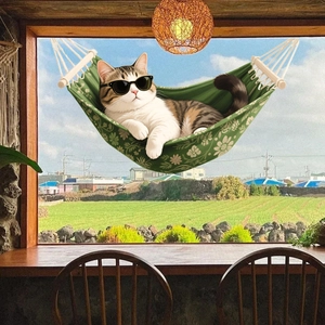 Hanging cat hammock with floral pattern on wooden frame shown fixed to a sunny window