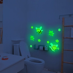 Luminous wall stickers set featuring cartoon bees and floral patterns in glow green