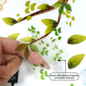 Close-up of clear adhesive green leaf wall sticker showing high transparency and PET material