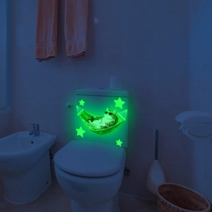 Glow-in-the-dark cat on a hammock wall sticker for bathroom decor in vibrant green