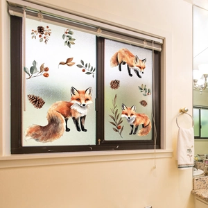 Detail of watercolor fox and autumn leaf static window decals on frosted glass