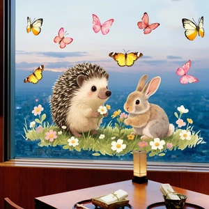 Detailed view of cartoon animal and flower static window stickers on a glass window