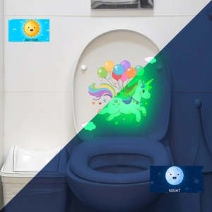 Luminous unicorn toilet lid sticker showing daytime color and nighttime green glow effect