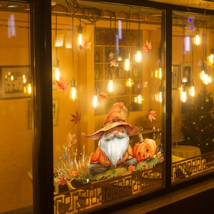 Detail of autumn window cling featuring a gnome with wizard hat, pumpkin, and maple leaves