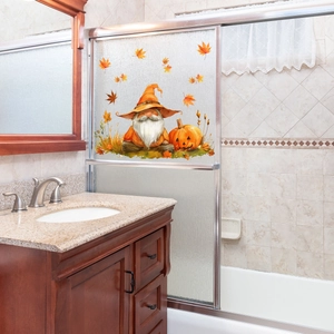 Close-up of fall window clings with gnome, pumpkin, and maple leaves on glass door