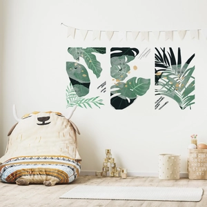 Three-piece tropical green leaf wall art decals in a cozy wooden nursery setting