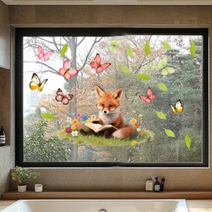 Detail of cartoon fox and butterfly static window clings on a glass window in a bathroom