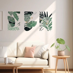 Three-piece wall art set with tropical monstera leaves and elegant gold ink splashes