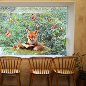 Detail of cartoon fox reading a book on a glass window with colorful butterfly stickers