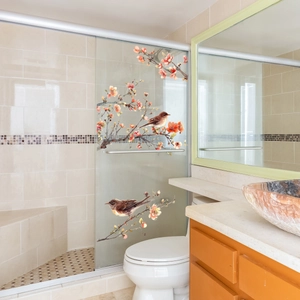 Detail view of bird and floral static window stickers on a glass shower door