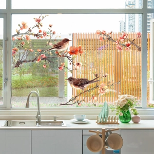 Detailed view of autumn gnome window clings featuring squirrels and fall maple leaf patterns