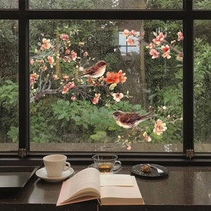 Detail view of static window decals showing brown birds and orange flowers on glass