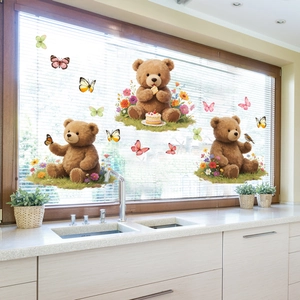 Close-up of cartoon bears and floral static window clings on a glass kitchen window