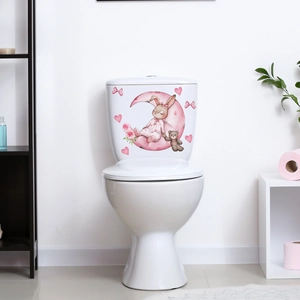 Close-up of luminous toilet sticker with watercolor rabbit on a pink moon decal