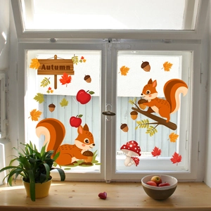 Close-up of fall window clings with squirrels, maple leaves, mushrooms and Autumn sign