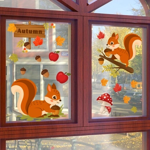 Detail of autumn window stickers featuring squirrels, maple leaves and mushrooms on glass
