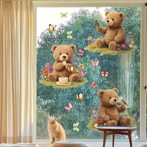 Detailed view of cartoon bear window clings with butterflies on a sunlit glass pane