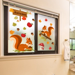 Detailed view of autumn window clings featuring cute squirrels, maple leaves, and acorns