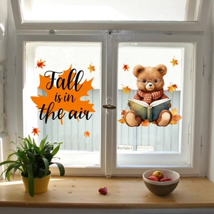 Detail of fall squirrel gnome window stickers featuring maple leaf and bear designs
