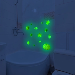 Glow-in-the-dark wall stickers featuring autumn pumpkin and maple leaf patterns in dark room