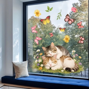 Detail of sleeping cats and colorful butterflies static window clings on glass