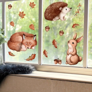 Detail of autumn forest animal window clings featuring watercolor hedgehogs and foxes