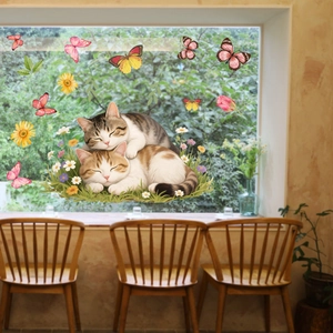 Detail of static cling window film with cats and floral patterns on glass window