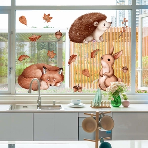 Detail of autumn forest window clings featuring watercolor fox, hedgehog and maple leaves