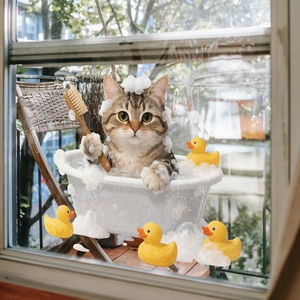 Detail of cat bathing static window cling sticker with rubber ducks and foam on glass