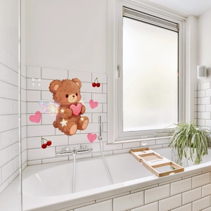 Detailed view of brown cartoon bear wall decals applied to white bathroom tiles