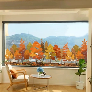 Detail view of autumn forest window stickers with orange and yellow leaves on a living room glass
